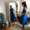 Woman in cobalt blue A-line dress at home